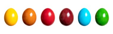 Rainbow colored Easter eggs, group of Paschal eggs, in in a row. Hard boiled, colorful dyed chicken eggs, traditionally used during Eastertide, as gift, decoration, for egg hunt and egg tapping games.