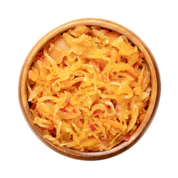 stock image Kimchi, in a wooden bowl. Traditional Korean side dish, made of salted and fermented vegetables cabbage, carrots, radish and onions, seasoned with garlic, ginger and the Korean chili powder gochugaru.