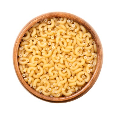 Gramigna, minute pasta, in a wooden bowl. Also called pastina, meaning little or small pasta. Uncooked, tiny elbow shaped tubes, made with durum, used as ingredient of soup, desserts, and infant food. clipart