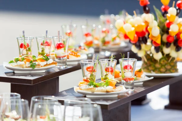 catering weddings table with snacks, canape with salmon on a white plate,catering weddings table