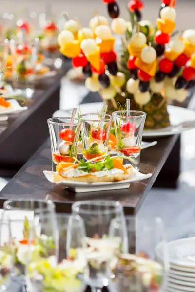 catering for wedding, catering weddings table with snacks, canape with salmon on a white plate,catering weddings table
