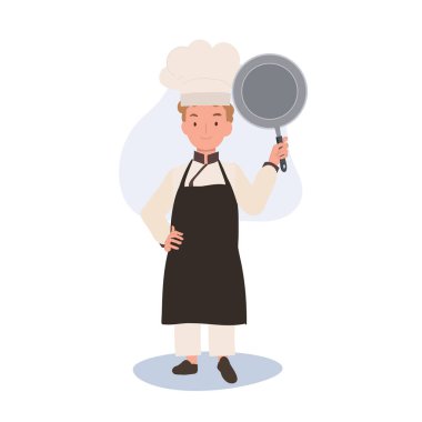 Şefin Şapkası ve Önlüğündeki Sevimli Çocuk Aşçı kızartma tavası gösteriyor. Pişirmeye hazır..