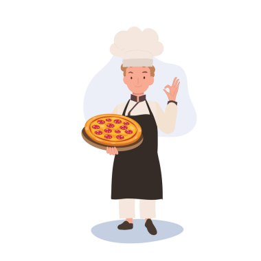 Genç aşçı tamam işareti gösteriyor. Mutlu Aşçı İyi Yapıyor El İşareti ve ev yapımı pizzayı diğer elinde tutuyor