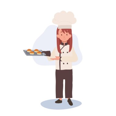 Aşçı şapkalı çocuk aşçısı ve önlüklü leziz bir çörek pişiriyor. Çocuk Şef gururla sunar Taze Ev Yapımı Çörek