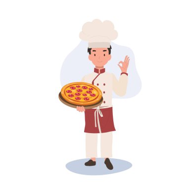Genç aşçı tamam işareti gösteriyor. Mutlu Aşçı İyi Yapıyor El İşareti ve ev yapımı pizzayı diğer elinde tutuyor