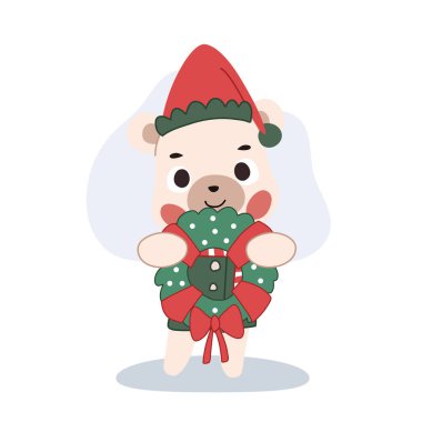 Şirin Noel Ayısı, kış süslemeleri için elinde bir çelenk tutuyor.