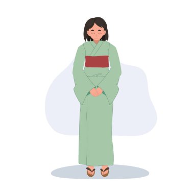 Yeşil yukata giyen genç bir Japon kadın saygıyla selamlıyor..