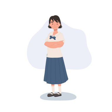 Kollarını kavuşturmuş okul üniformalı genç bir Taylandlı.,