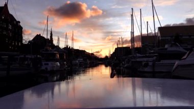 Kopenhag, Danimarka. Günbatımında Christianshavn Kanalı 'ndan geçen bir kanal motoru.. 