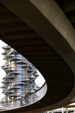 Copenhagen, Denmark Bicyclists on the Cykelslangen bicycle bridge and the Cactus Towers in the background.