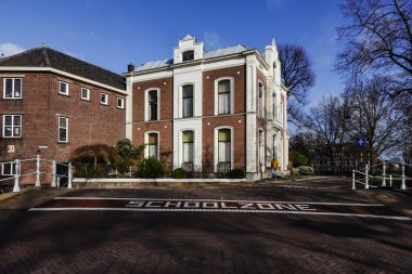 Delf, Netherlands A school zone sign on a street on a bridge crossing a canal.