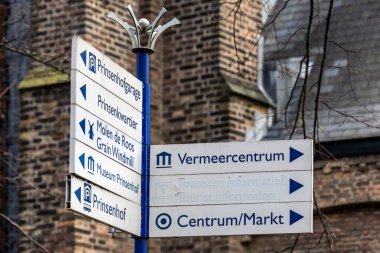 Delf, Netherlands A street sign pointing towards tourist spots.