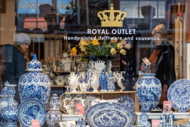 Delf,Netherlands,  People in a shop window looking at Delfware souvenirs.