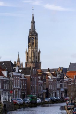 Delf, Netherlands A picturesque canal in the downtown and the Old Church, Oude Kerk.