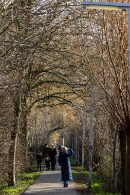 Delf, Netherlands People walking on a path on a sunny day in winter.