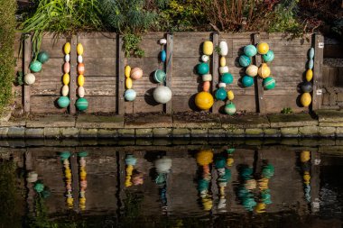 Delf, Netherlands  Small colorful buoys on the side of a canal