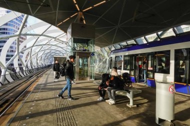 The Hague, Netherlands People on the platform of a   modern elevated tram system in the downtown.