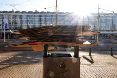 The Hague, Netherlands Flattened cardboard boxes are piled on top of a municipal waste and litter bin.