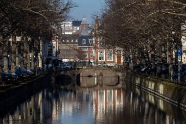 The Hague, Netherlands,  A view of a small canal in the downtown on Smidswater and a cyclist on a bridge.