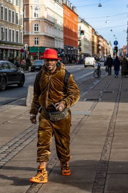 Copenhagen, Denmark  A brightly dressed man with a red hat walking on Istegade in the Vesterbro district.