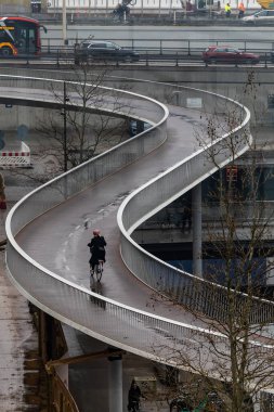 Copenhagen, Denmark Bicyclists on the landmark bicycle bridge called Cykelslangen.