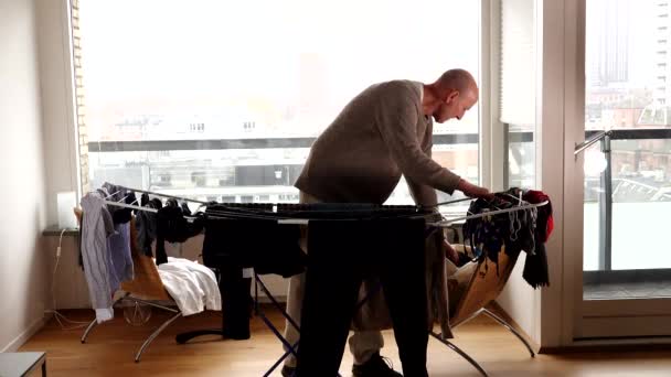 Man Hangs Laundry Dry Rack Apartment — Wideo stockowe