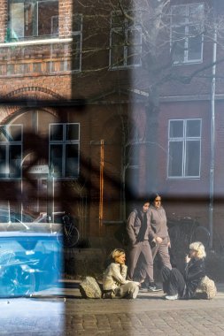 Kopenhag, Danimarkalı yayalar Norrebro semtindeki sokakta bir butik pencereden ve yansımalardan görüldü..