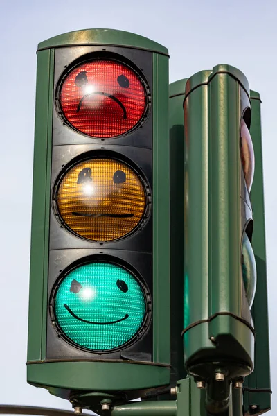 Copenhagen, Denmark Traffic lights with painted faces. Green for Happy. Red for sad.