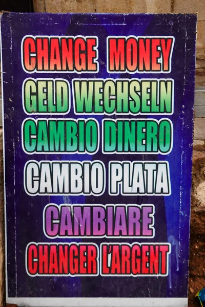 Kerak, Jordan, A change money sign on thr street in multiple languages.