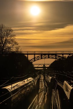 Kopenhag, Danimarka Carlsberg viyadük, 1899 'dan kalma çelik bir yaya köprüsü ve gün batımında tren rayları..