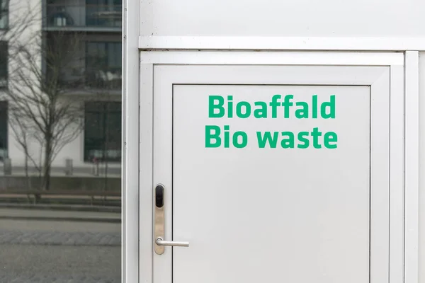 Copenhagen, Denmark A sign for Bio waste in Danish and English on the door of an aprtment building.