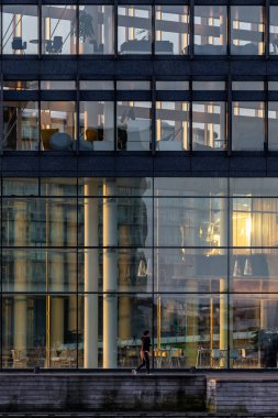 Kopenhag, Danimarka Modern Fisketorvet bölgesinde sabahın erken saatlerinde koşan bir koşucu.