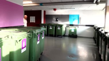 Stockholm, İsveç 'te bir adam konut kompleksindeki süper temiz ve düzenli bir çöp odasına çöp atıyor.. 