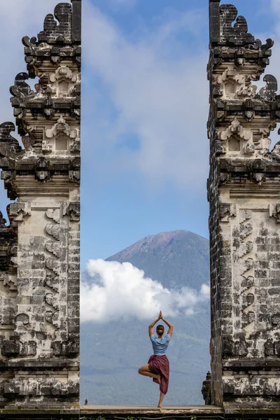 Stock image Lempuyang Temple, Bali, Indonesia  A woman tourist does a yoga pose  at the Lempuyang Hindu Temple in eastern Bali.