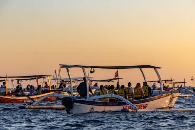 Geleneksel Endonezya balıkçı teknelerinde Lovina Sahili, Bali, Endonezya Turistleri şafak vakti yunusları tespit etmeye çalışırlar..