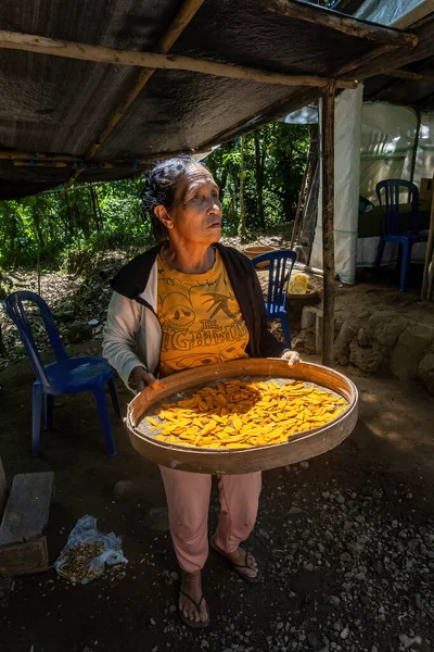 stock image Bali, Indonesia May 15, 2023 A local woman sells dried  turmeric spice on a path in the jungle.