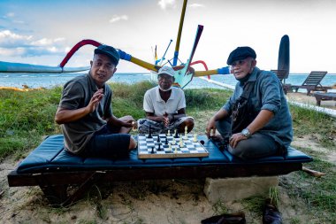 Sanur, Bali, Endonezya Sahilde satranç oynayan yerel adamlar.