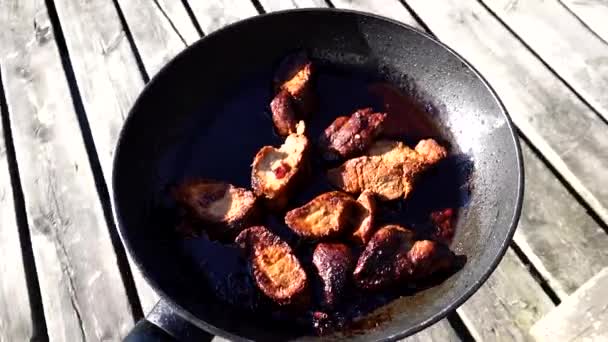 Person Carries Fried Pork Loin Frying Pan Outdoor Wooden Patio — Stock Video