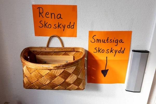 Stockholm, Sweden A basket on a wall at the entrance to a community center says in Swedish \