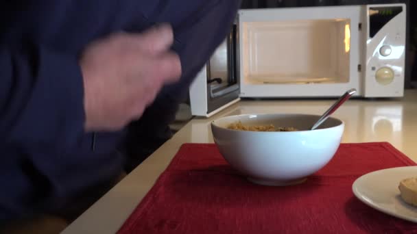 Man Eats Bowl Risotto Dinner Himself Next Microwave Oven Kitchen — Stock Video