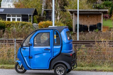 Vejle, Danimarka. 30 Ekim 2023. Küçük, şık bir motosiklet aracı uzun bir bisiklet yolunda yarışıyor..