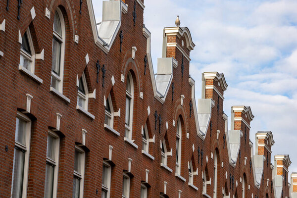 The Hague, Netherlands Nov 12, 2023 Narrow brick row residential houses on a suburban street.