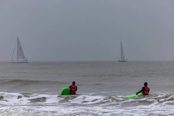 stock image The Hague, Netherlands Nov 12, 2023 Surfers in the water with wetsuits  on the Scheveningen beach.