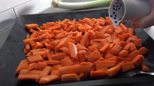 Cook Pours Olive Oil Sliced Carrots Roasting Tray — Stock Video