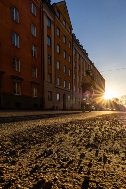 Stockholm, Sweden March 11, 2024 A bicyclist at sunset on Heleneborgsgatan in the Sodermalm district. clipart