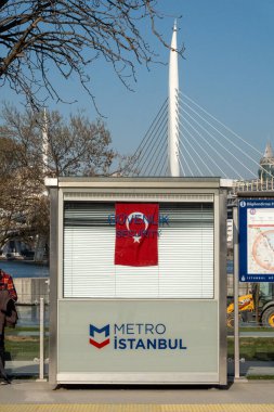 Istanbul, Turkey March 19, 2024 A small booth with a sign for Metro Istanbul on an outdoor tram line besides the Ataturk Bridge. clipart