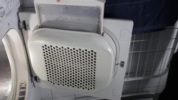 Man Removes Lint Electric Clothes Tumble Dryer — Stock Video