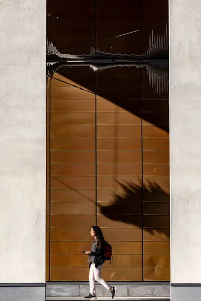 stock image Stockholm, Sweden May 13, 2024 A woman walks by the facade of the Royal Music Academy