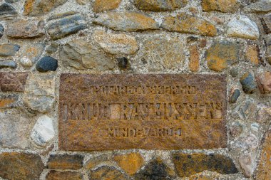 Hundested, Denmark May 27, 2024 A stone monument to famed Arctic explorer Knud Rasmussen.and plaque. clipart