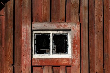 Stockholm, İsveç Sollentuna banliyösünde kırmızı ahşap bir kulübe ve borken pencere..